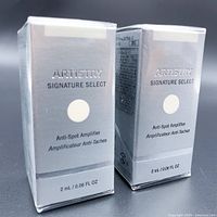 Two unopened boxes of Artistry Signature Select Anti-Spot Amplifier each 2 mL in size standing side by side.