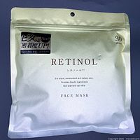 Front of resealable silver metallic bag displaying Retinol Face Mask with 30 sheets quantity and branding in Japanese and English.