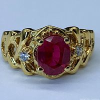Front view showing center oval red ruby and one white sapphire accent