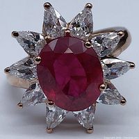 Top view showing central oval ruby and surrounding white sapphire petals