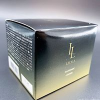 Photo showing front side of the Leola Moisture Cream box with branding and product name.