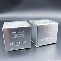 Two silver boxes of La Prairie Skin Caviar Luxe Cream placed side by side showing front face with brand and product name.