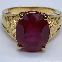 Front view showing oval pigeon blood ruby and prong setting