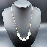 Front view of the necklace showing the five large translucent Venetian glass beads on the silver chain.