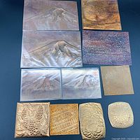 Full layout of all copper sheets displaying embossed mountain landscapes and decorative motifs