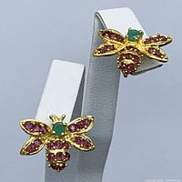 Front view of both bee-shaped earrings showing emerald heads and rhodolite garnet encrusted wings and bodies in gold plated sterling silver.