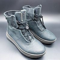 Front angled view of pair of black Gore-Tex Solice mid-cut boots showing the toe box, lacing system with toggle lock and mid-top ankle height.