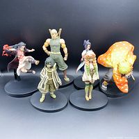 Group photo showing all six figurines from the Demon Slayer anime series positioned on round black bases against black background.