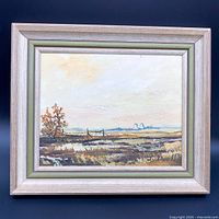 Front view of original framed landscape painting on board signed by J. Doell showing autumnal tree and rural marsh scene.