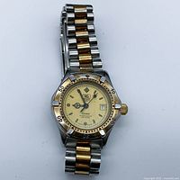 Full front view of watch and bracelet laid flat