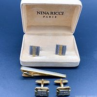 Image showing vintage Nina Ricci cufflinks and tie clip inside branded presentation box