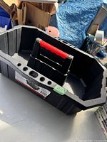 Top view of the black Husky tool caddy showing its interior compartments and red and black handle.