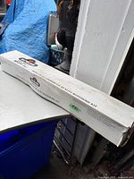 White box labeled 'Napoleon Gas Grills Heavy Duty Commercial Quality Rotisserie Kit'