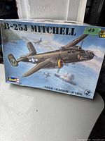 Box of vintage Revell B-25J Mitchell plastic model kit showing detailed artwork of the warplane in flight with combat background. Box labeled 1:48 scale and plastic kit.