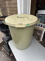 Full view of vintage Rubbermaid garbage can with lid showing size and shape