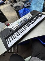 Full view of Yamaha EZ-150 keyboard showing entire key range and built-in speakers.