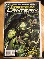 Green Lantern Rebirth comic book issue #3 cover featuring three characters with glowing rings, titled 'Unholy Trinity'.
