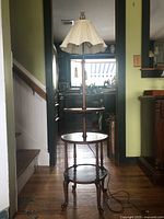 Front view of the 3 tier antique end table with built-in lamp and two-way light.