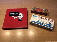 Three vintage games Po-Ke-No, Flinch, Crown Dominoes in original boxes with visible age wear.