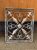 Front view of the metal decor piece showing overall shape and design.