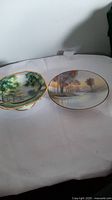 Two handpainted Noritake porcelain items, a bowl and an oval dish, displayed to show landscape artwork.