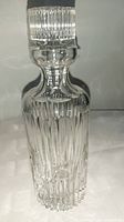 Full view of the clear vintage crystal decanter with intricate cut glass design and stopper.