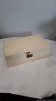 Closed view of the vintage white leather jewellery box showing lock on front.