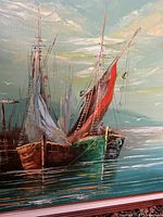 Close-up of the sailboats with visible texture in the paint and vibrant colors of sails and hulls.