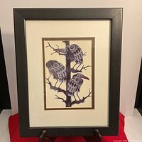 Frontal photo of the framed print showing three birds on a tree branch in indigenous art style.