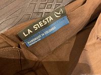 Close-up photo of La Siesta brand tag showing hammock is handmade in Colombia