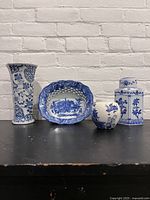 Photo showing entire lot including vase, berry bowl, and two ginger jars against white brick wall