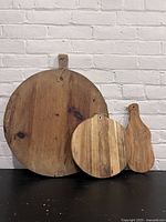 Full view of all three wooden cutting boards showing their size and shape next to each other.
