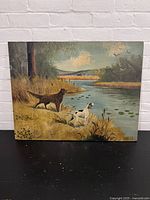Front view of the vintage painting showing two dogs near a water body, signed T. Foster.