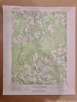 Full view of one geological map showing terrain with green vegetation shading and contour lines.