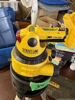 Close-up of Stanley Strait-Line laser level showing bubble vial and adjustment knob.