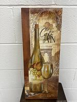 Front view of the art print on canvas with a vintage wine theme showing a large Chardonnay wine bottle, a wine glass, grapes, and the text 'Cafe D'Vin'.