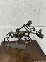 Front angled view of the metal art horse sculpture showing abstract design and construction from bolts and rods.