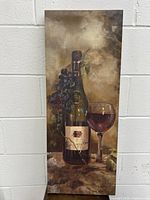 Front view of the wall poster on canvas depicting a wine bottle, grapes, and wine glass artwork in warm brown tones.