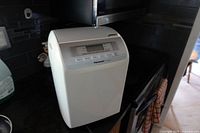 Front and top view of white Panasonic bread maker on countertop