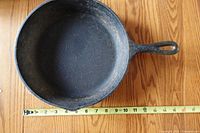 Top view showing interior cooking surface and size reference with tape measure