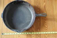 Top view showing interior cooking surface and ruler indicating roughly 12-inch diameter