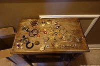All costume jewellery pieces spread on small wooden table