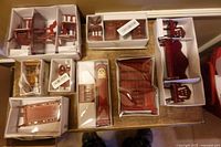 Seven unopened boxes containing assorted mahogany-tone dollhouse furniture pieces