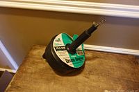 Overall view of the 15-ft drum drain auger showing drum housing, handle, and label