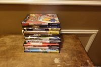 Stack of 10 Nintendo GameCube game cases on wooden surface