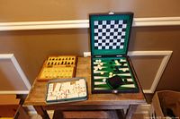 Overview of three travel board games on table