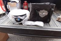 Grill components wrapped in bubble wrap and branded carry bag on truck tailgate