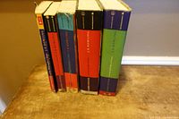 Five Harry Potter hardcovers standing spine-out on table