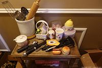 Overall lot with utensil crock, tools, ceramic items and novelty shakers on wooden table