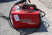 Overall view of Lincoln Electric MIG welder with cables and handle